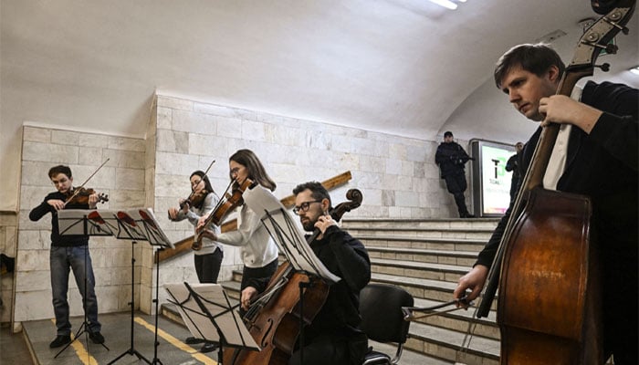 Musicians play for displaced people at metro station in Kharkiv