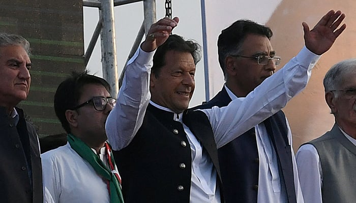 Prime Minister Imran Khan along with other lawmakers, gestures upon his arrival to address the supporters of PTI during a rally in Islamabad on March 27, 2022. — AFP