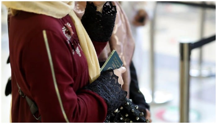 An Afghan woman holds her passport at the international airport in Kabul, Afghanistan, September 9, 2021. Photo: Reuters/ file