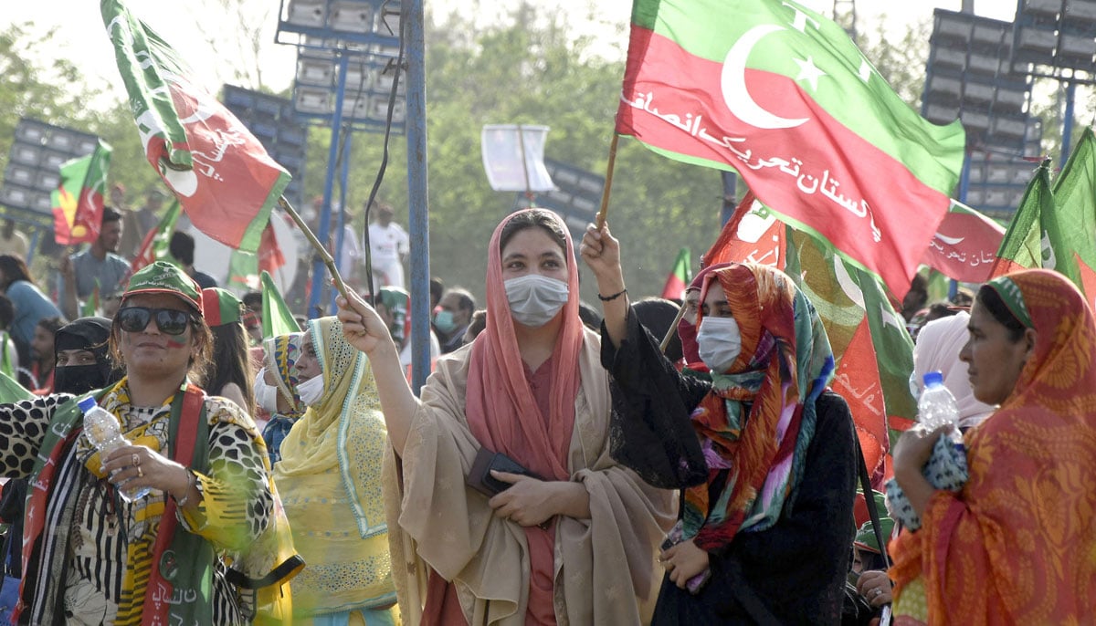 PTI supporters hold party flags during its historic public gathering (jalsa) at Parade Ground, in Islamabad. — Online