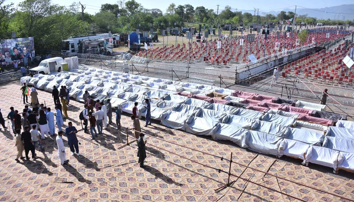 Workers of PTI arranging seating for the public meeting of Prime Minister Imran Khan at Parade Ground in the federal capital. — APP