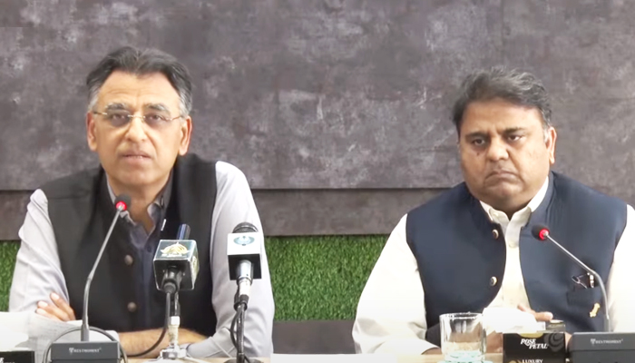 Federal Minister for Planning, Development, and Special Initiatives Asad Umar (left) addressing a press conference along with Information Minister Fawad Chaudhry (right) in Islamabad, on March 29, 2022. 1 YouTube/HumNewsLive