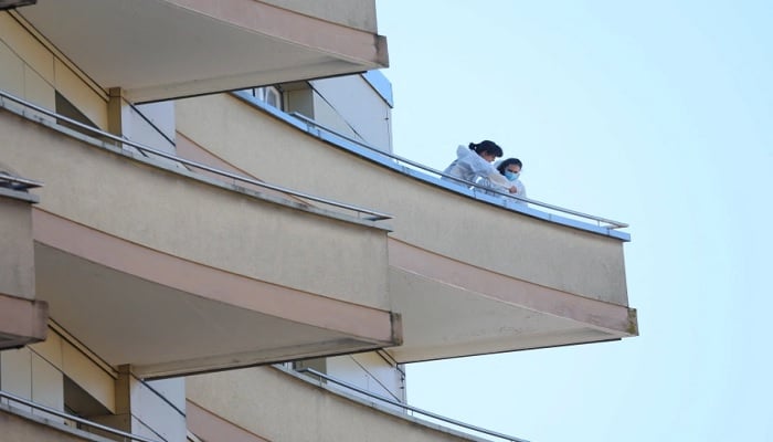 Police officers take samples on a balcony after five people appeared to have jumped from their apartment in Montreux.—Reuters