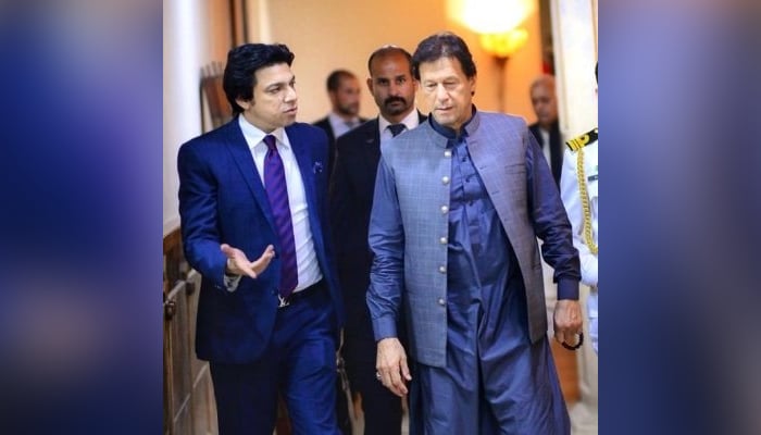 Former federal minister Faisal Vawda (left) speaks with Prime Minister Imran Khan in this undated photo. — Twitter/@faisalvawdapti