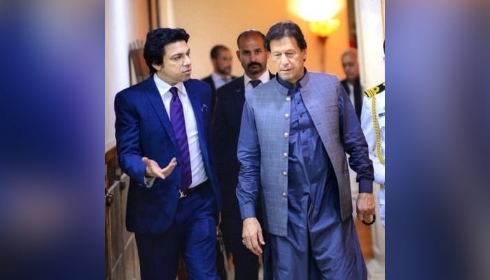 Former federal minister Faisal Vawda (left) speaks withPrime Minister Imran Khan in this undated photo. — Twitter/faisalvawdapti