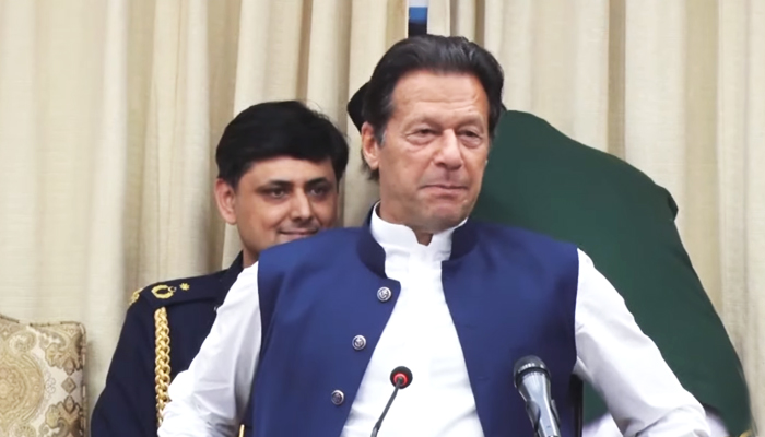 PM Imran Khan talking to his party leaders after successfully evading the no-trust move against him. — Screengrab via Hum News Live