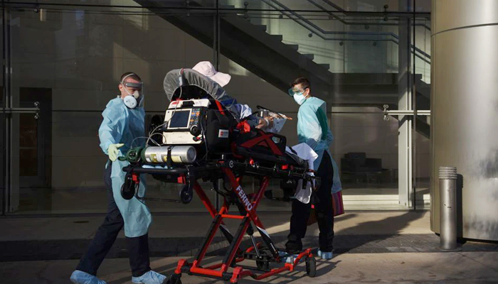 Orion EMS employees wheel a patient who tested positive for the coronavirus disease (COVID-19) on a stretcher in Houston, Texas, US, August 19, 2020. — Reuters