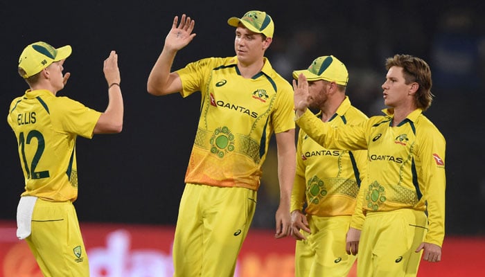 Australias players celebrate after the dismissal of Pakistans captain Babar Azam (not pictured) during the T20I between Pakistan and Australia at the Gaddafi Cricket Stadium in Lahore. —  AFP