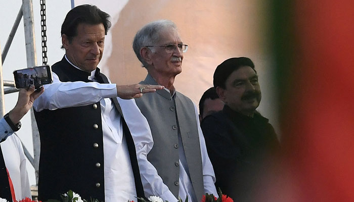 Prime Minister Imran Khan (from left) standing with other PTI leaders, gestures upon his arrival to address PTI supporters during a rally in Islamabad on March 27, 2022. — AFP
