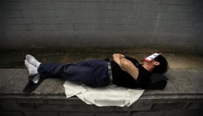 (Representational) A petitioner sleeps with a bus timetable covering his face on a street outside a government office in Beijing July 20, 2008. Reuters