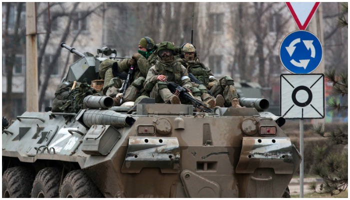 Servicemen ride atop a Russian armoured vehicle in Armyansk, Crimea, on February 25, 2022. — AFP/File