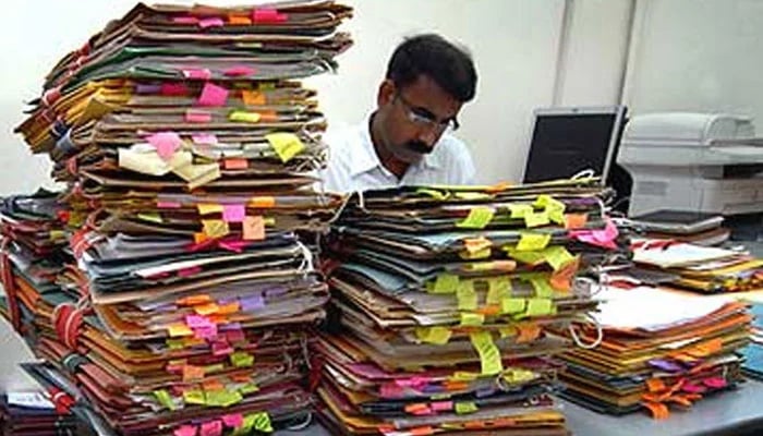 A representational image of a government employee working in his office. — Geo Urdu/File