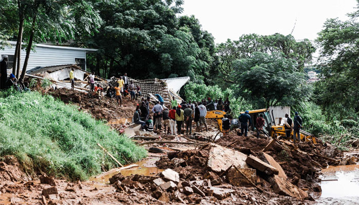 People dig for a Muslim worshipper believed to be trapped after a local mosque collapsed following heavy rains and winds in Durban, on April 12, 2022. Photo— RAJESH JANTILAL / AFP