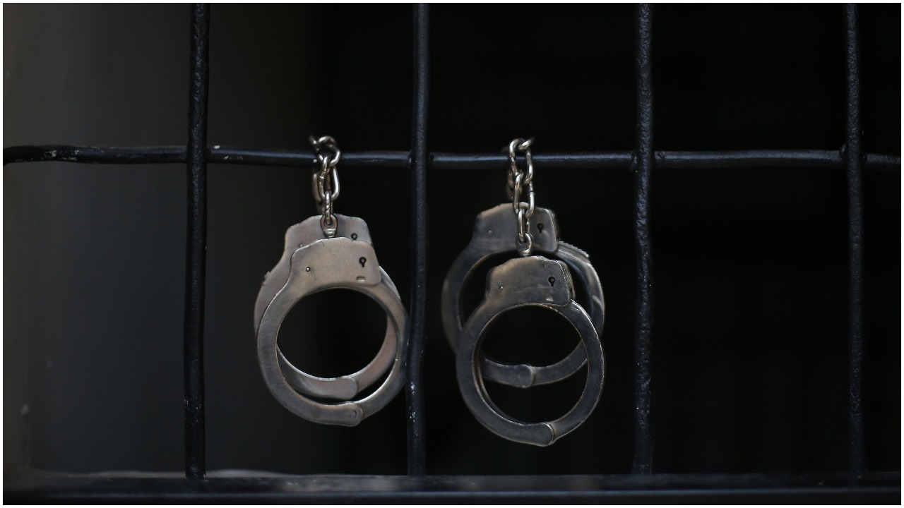 Handcuffs are seen hanging on the bars. — Reuters