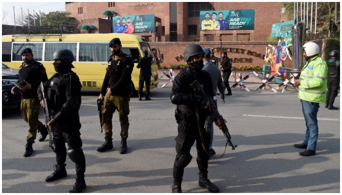 Security personnel stand guard ahead of the start of a cricket match, outside the Gaddafi Stadium in Lahore. — AFP/File