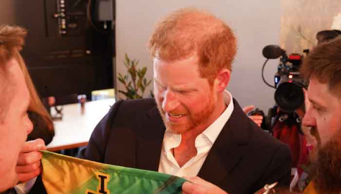 The Australian Invictus Games team presents Prince Harry with a gift for moving to California