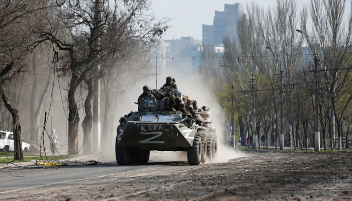 Service members of pro-Russian troops ride an armoured personnel carrier during Ukraine-Russia conflict in the southern port city of Mariupol, Ukraine April 15, 2022. -Reuters