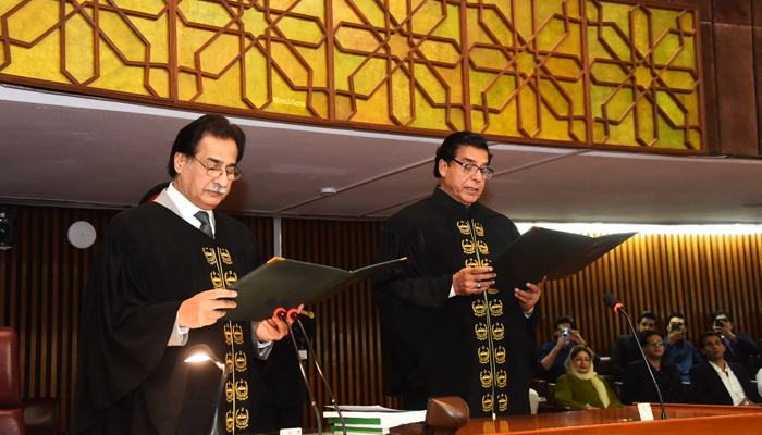 PPP leader and MNA Raja Pervez Ashraf (right) PML-N leader and MNA Ayaz Sadiq administers the oath to the newly-elected speaker of the National Assembly in Islamabad, on April 16, 2022. — Twitter/NAofPakistan