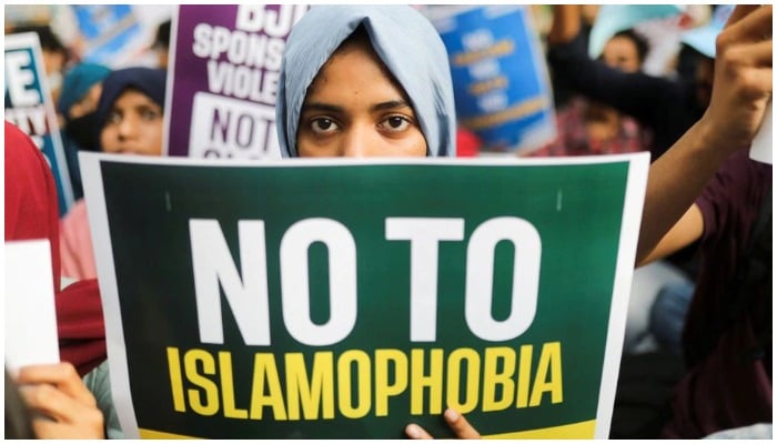 A citizen holds a placard during a peace vigil organised by citizens against what they say is rise in hate crimes and violence against Muslims in the country, in New Delhi, India, April 16, 2022. — Reuters