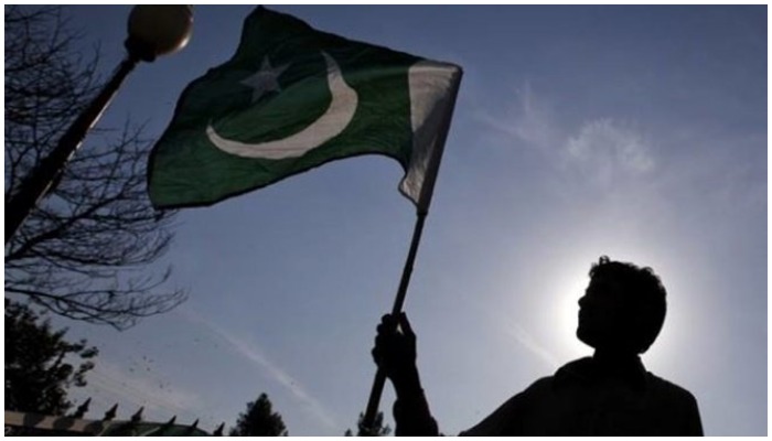 Picture shows a person holding a Pakistani flag. — Reuters/File