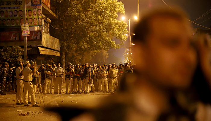 Police personnel stand guard after clashes broke out during a Hindu religious procession in the Jahangirpuri area of New Delhi, India, April 16, 2022. 1 Reuters