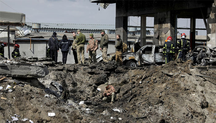 Ukrainian servicemen and rescuers inspect the site of military strikes on buildings as Russias attack on Ukraine continues, in Lviv, Ukraine. Photo— REUTERS/Roman Baluk