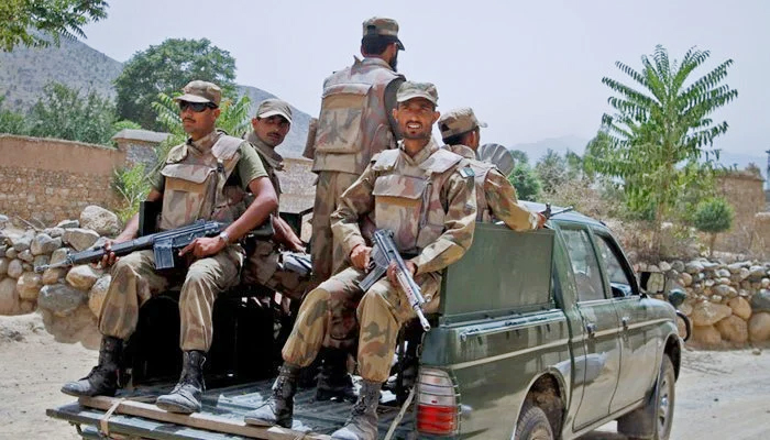 Armed security forces personnel riding in a military van. — AFP/File