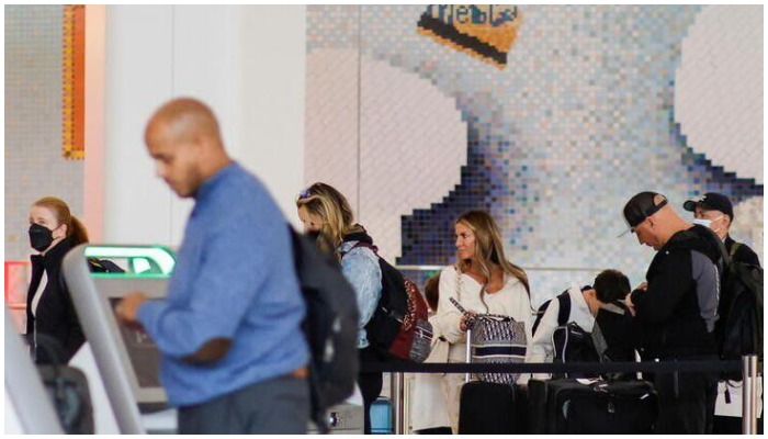 People without masks arrive to the counter for check in at La Guardia Airport in New York, US. — Reuters