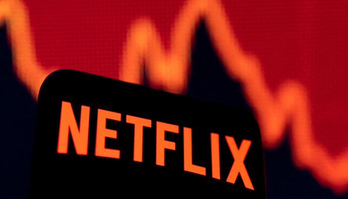 Smartphone with Netflix logo is seen in front of a descending stock graph in this illustration taken April 19, 2022. — Reuters