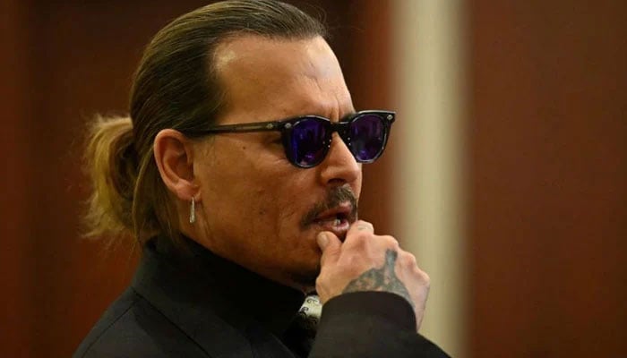 Amber Heard leaks photos of Johnny Depp ‘passed out’ on the couch