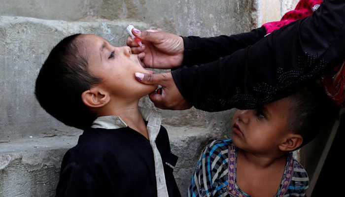 A boy receives polio vaccine drops, during an anti-polio campaign, in a low-income neighbourhood in Karachi, Pakistan April 9, 2018. — Reuters/File