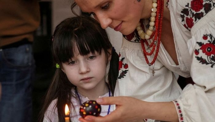A girl looks at an Easter egg painted in the traditional style during a lesson for children of families fleeing from Russias invasion of Ukraine as part of the upcoming celebrations of Easter, in central Kyiv, Ukraine April 22, 2022. — Reuters