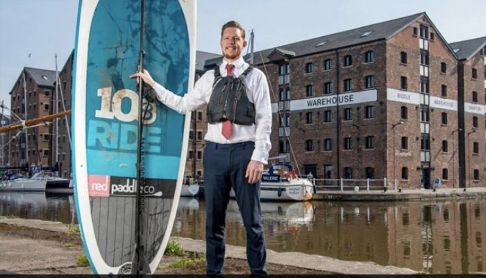 Alex Kell with his paddleboard.—LinkedIn/quaysideweallthmanagement