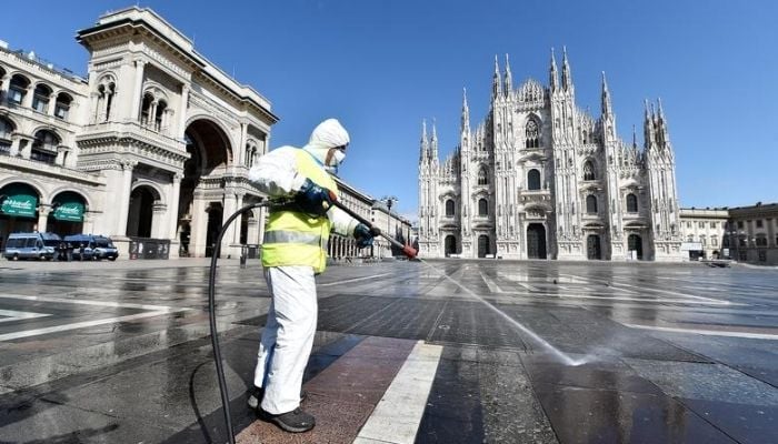 A worker wearing protective garments sanitises the Duomo square, during the coronavirus disease (COVID-19) outbreak in central Milan, Italy March 31, 2020.— Reuters