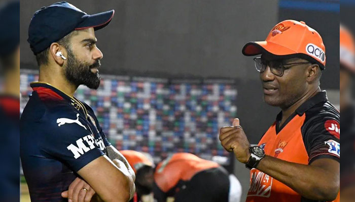 India’s former captain Virat Kohli (L) takes batting tips from Brian Lara (R).