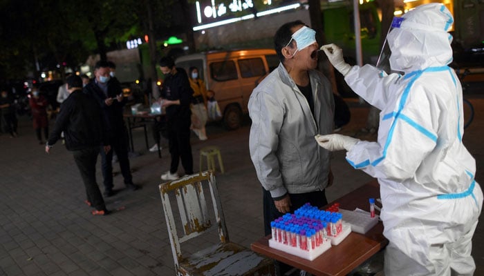 This photo taken on April 19, 2022 shows a resident undergoing a nucleic acid test for the COVID-19 coronavirus in Wuhan in China´s central Hubei province. — AFP