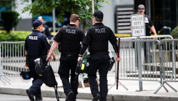 Seattle Police officers carry gear as they walk towards the Seattle Police Departments West Precinct in Seattle, Washington, U.S. June 10, 2020. — Reuters