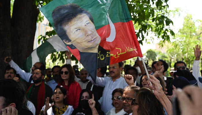 PTI supporters chant slogans during a protest against the biased attitude of the chief election commissioner and to demand immediate general elections in the country, outside the ECP office in Islamabad on April 26, 2022. — AFP