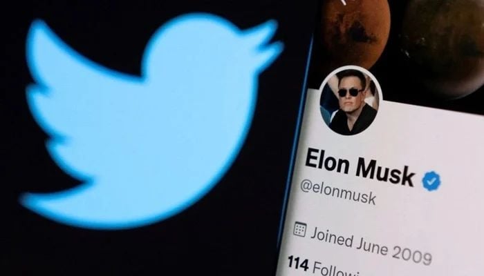 Elon Musks Twitter account is seen on a smartphone in front of the Twitter logo in this photo illustration taken, on April 15, 2022. &mdash; Reuters