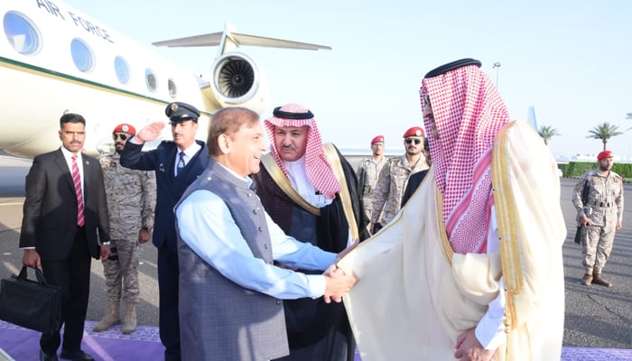 Prime Minister Shehbaz Sharif (left) shakes hands with Governor Madina Faisal bin Salman Al Saud at Madina, Saudi Arabia after landing in the Kingdom for his maiden three-day visit to the Kingdom, on April 28, 2022. — Prime Ministers Office