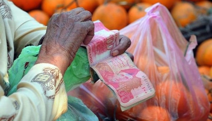 The picture shows a person counting money. — AFP/File