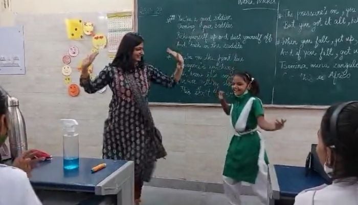 Government school teacher dances with her student. .—Screengrab via Twitter/ManuGulati11