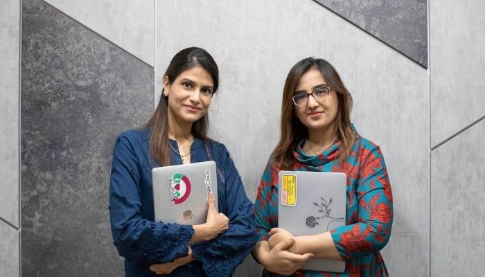 Sara Saeed Khurram (L), co-founder and CEO of health tech company Sehat Kahani, and Iffat Zafar (R), co-founder and COO of Sehat Kahani, pose for a photo at their office in Karachi, Pakistan on April 14, 2022.— Thomson Reuters Foundation/Khaula Jamil.