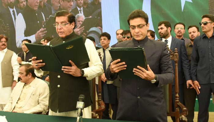 National Assembly Speaker Raja Pervaiz Ashraf (L) and Chief Minister of Punjab Hamza Shahbaz Sharif standing for the national anthem of Pakistan during the oath-taking ceremony on April 30, 2022.— Twitter/pmln_org