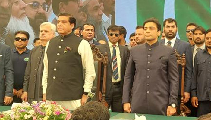 National Assembly Speaker Raja Pervaiz Ashraf (L) and Chief Minister of Punjab Hamza Shahbaz Sharif standing for the national anthem of Pakistan during the oath-taking ceremony on April 30, 2022.— Twitter