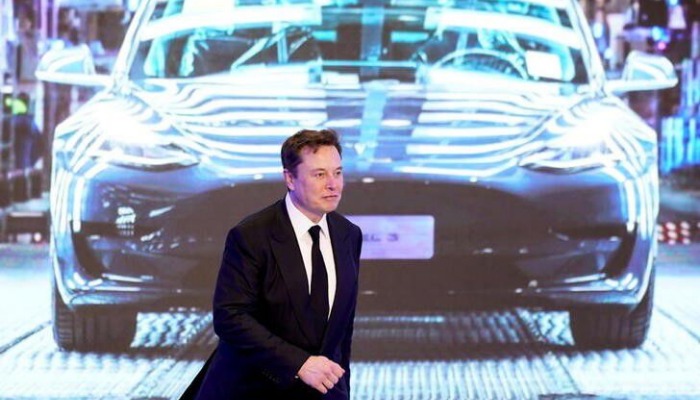 Tesla Inc CEO Elon Musk walks next to a screen showing an image of Tesla Model 3 car during an opening ceremony for Tesla China-made Model Y program in Shanghai, China January 7, 2020. — Reuters/File