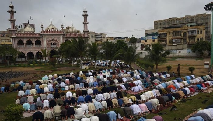 Pakistani Muslims offer Eid-ul-Adha prayers outside a mosque in Karachi on September 2, 2017. — AFP