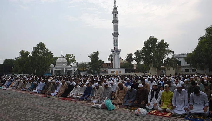 Pakistani Muslims offer Eid-ul-Adha prayers outside a mosque in Rawalpindi on August 22, 2018. — AFP