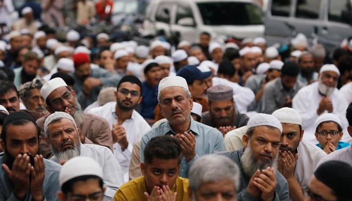Men attend Eid al-Adha prayers outside a mosque along a street in Karachi, Pakistan August 12, 2019. — Reuters