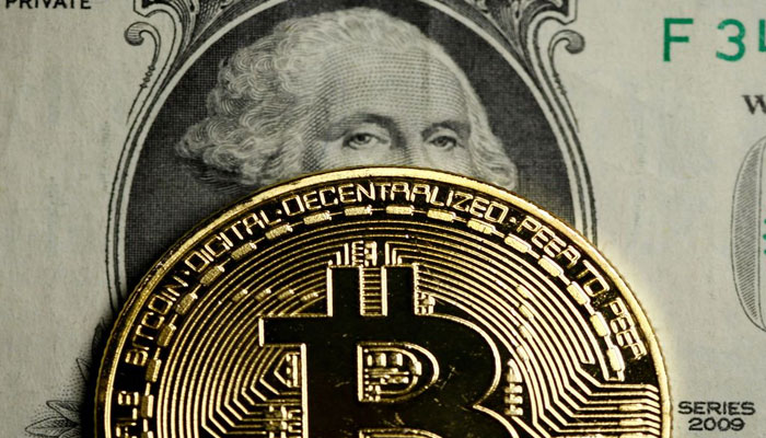 A Bitcoin and Dollar note are seen in this illustration picture taken September 27, 2017. — Reuters/File